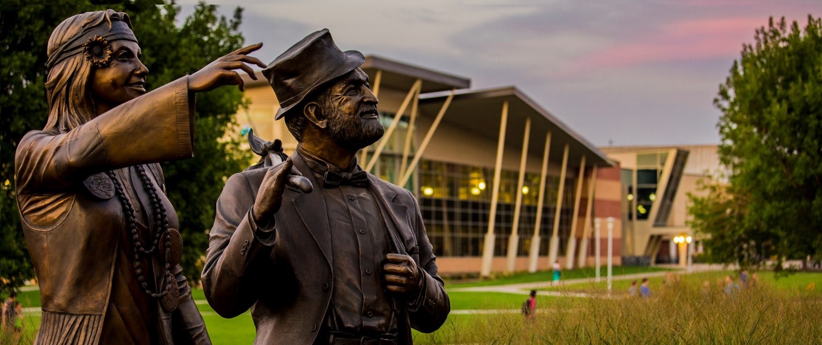 View of Weary Wil and Dirty Lil statues with Wellness Center in the background.